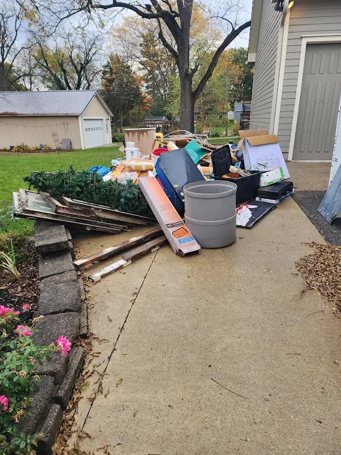 Dumpster being loaded with debris for 3 Yard Dumpster Rental in O'Fallon